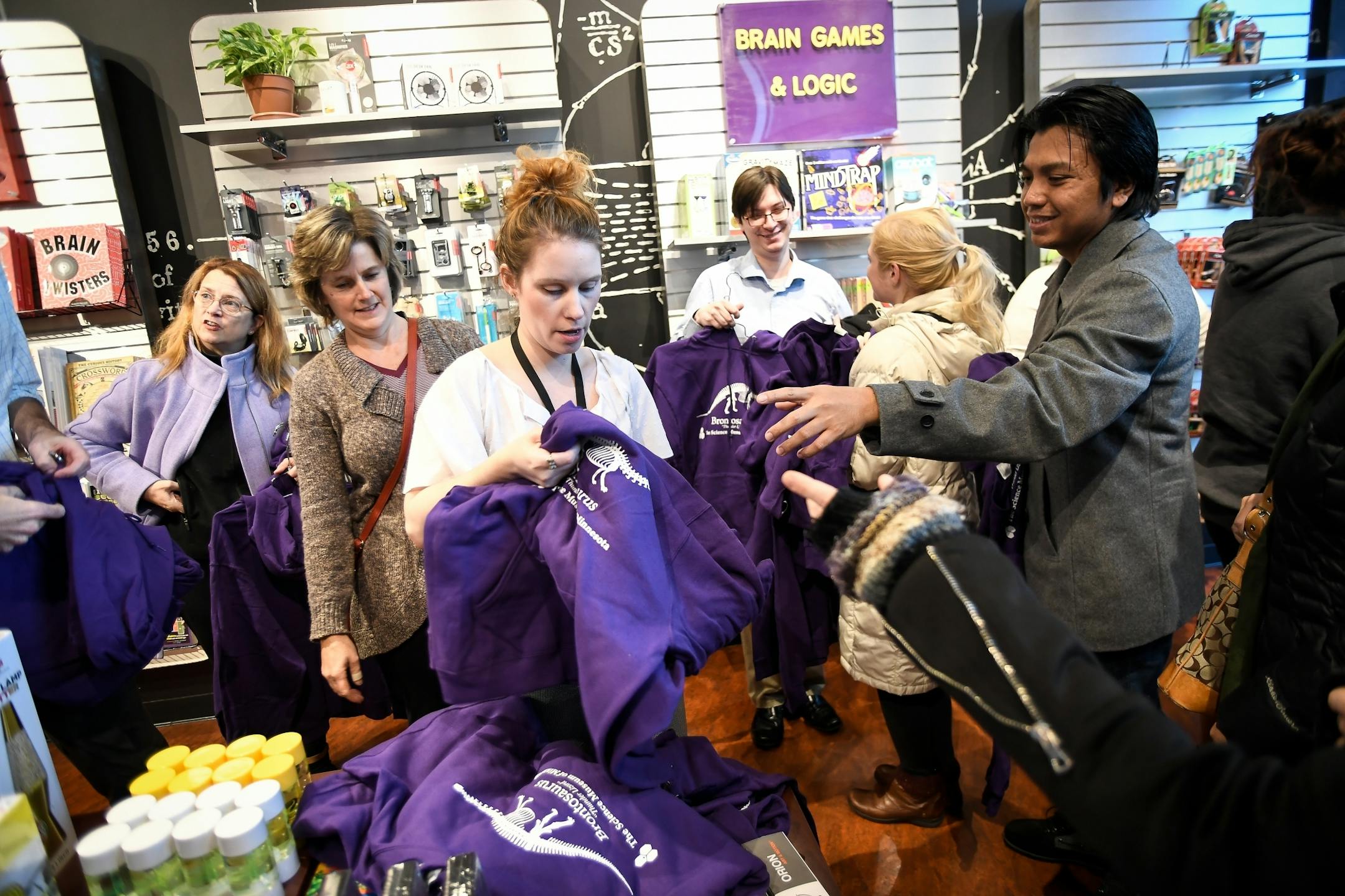 Kate Johnson, an employee with the Science Museum of Minnesota gift shop, handed out Brontosaurus hoodies to customers Tuesday morning.