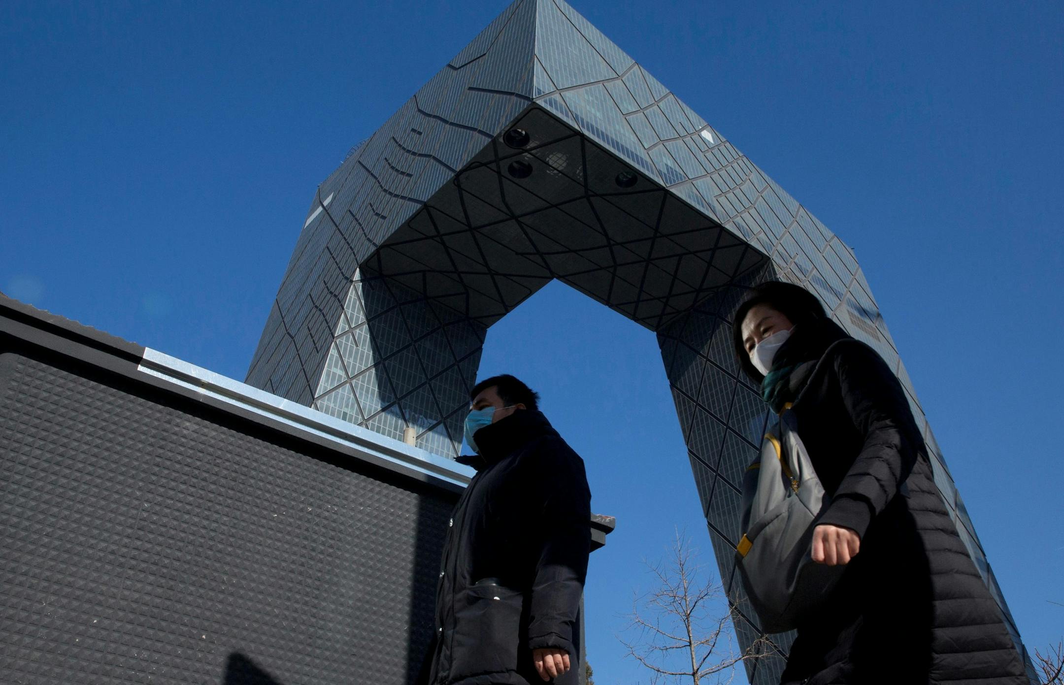 Residents enjoy a clear day near the iconic CCTV headquarters after a cold front pushed out heavy pollution from Beijing, China, Thursday, Dec. 22, 2016. Beijing and dozens of other cities under a five-day "red alert," the highest level in China's four-tiered warning system gained some reprieve from the smog that affected 460 million people forcing closed schools, grounded hundreds of flights and announced emergency shutdowns of factories and highways. (AP Photo/Ng Han Guan) ORG XMIT: XHG102