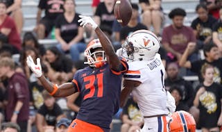 Illinois defensive back Devon Witherspoon breaks up a pass in the end zone intended for Virginia's Lavel Davis Jr., during the second half of an NCAA 
