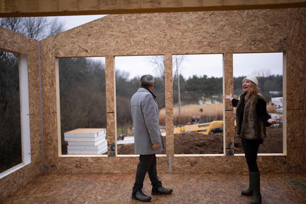 Broker Richard McDonough gave designer and developer Amy Matthews a tour of a new construction green home being built by Greensmith on Friday in Stillwater. They were walking through the house's sunroom.