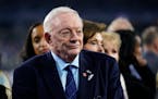 Dallas Cowboys team owner Jerry Jones stands for the playing of the national anthem before an NFL football game against the Indianapolis Colts Sunday,