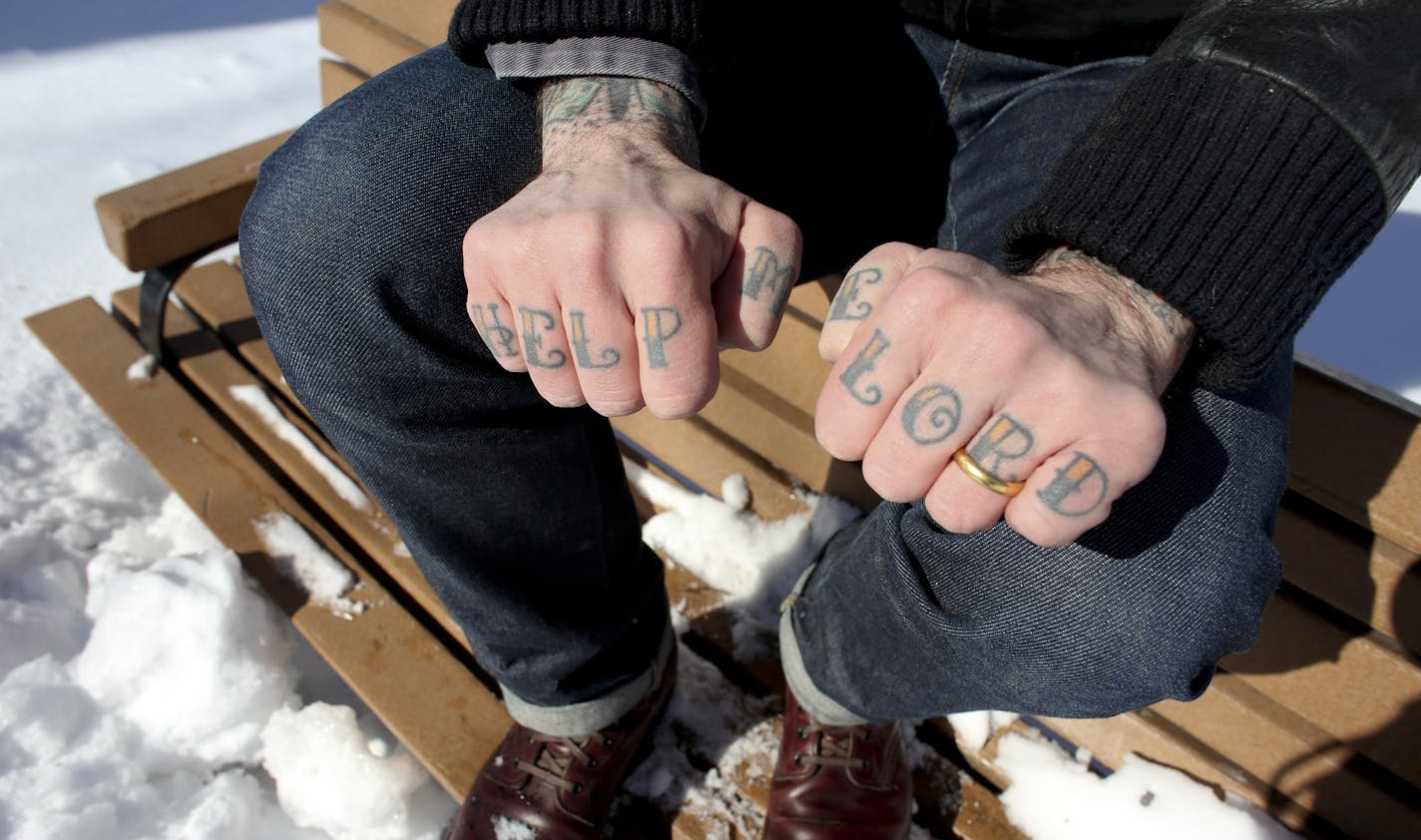 Jay Bakker, son of Jim and Tammy Fay, showed one of his tattoos while on a bench in Elliot Park where his parents use to meet when they went to North Central University in Minneapolis, Min., Wednesday, March 20, 2013. ] (KYNDELL HARKNESS/STAR TRIBUNE) kyndell.harkness@startribune.com