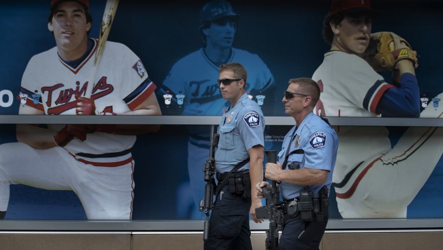 Minneapolis Police officers A. Allen left, and S.J Laux and SWAT team members stood outside Target Field after the Twins game as a reaction to the mass shooting that happened in El Paso Texas Sunday August 4, 2019 in Minneapolis, MN.