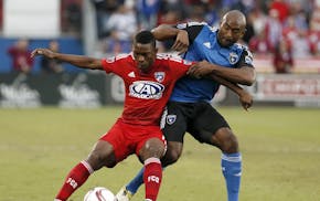 FC Dallas midfielder Fabian Castillo (11) fight for control of the ball against San Jose Earthquakes's Marvell Wynne, right, in the first half of an M