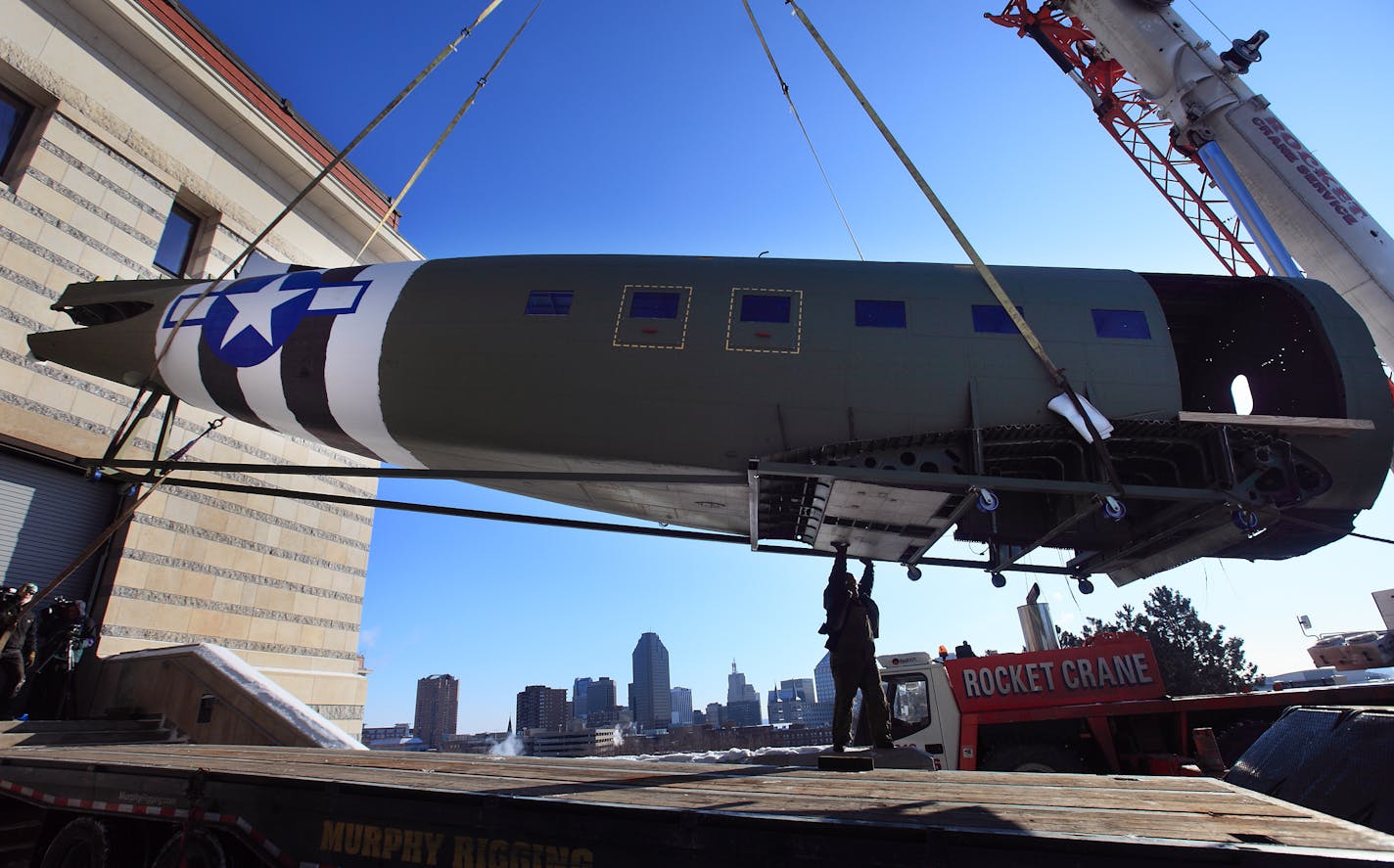 At the Minnesota History Center in St. Paul, Bob Biczen of Rocket Crane Service helped guide the fuselage of a restored 1943 Douglas C-47 to the loading bay. The artifact will be the largest at "Minnesota's Greatest Generation: The Depression, The War, The Boom." The exhibit opens May 23. A volunteer group of military veterans and non-veterans worked for months to restore the C-47 for the exhibit.