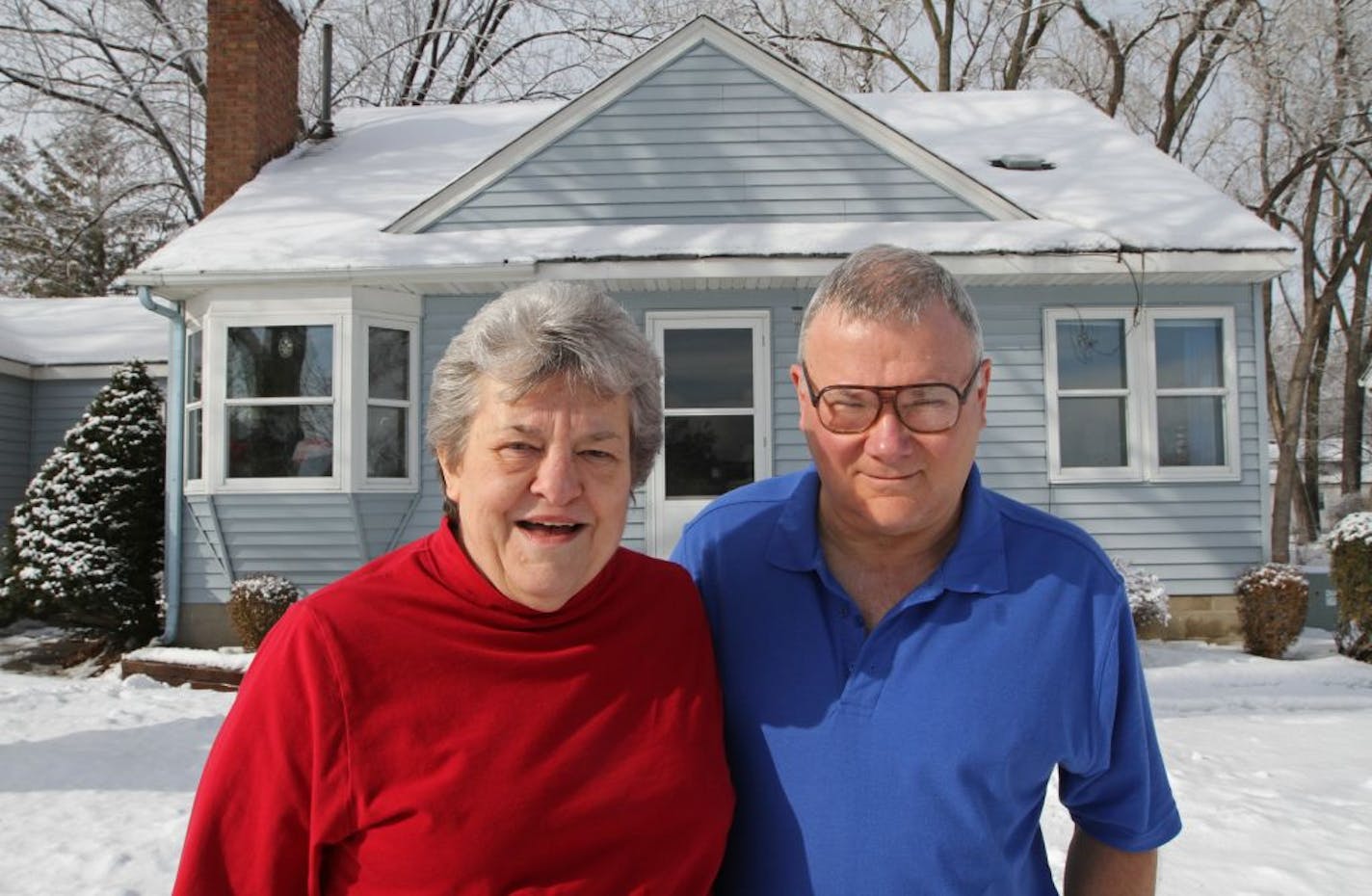 (left to right) After a decade of waiting, Trisha and Andy Hartle are finally selling their Richfield house. The blue Cape Cod sits on 17th Ave. S. across from the gigantic retail campus on 66th St. anchored by Home Depot and Target. The Hartles and a dozen other homeowners have been expecting to be bought out for years, delaying repairs on their homes, yet unable to sell. The Hartles can't wait to get out. Photographed on 2/14/13.