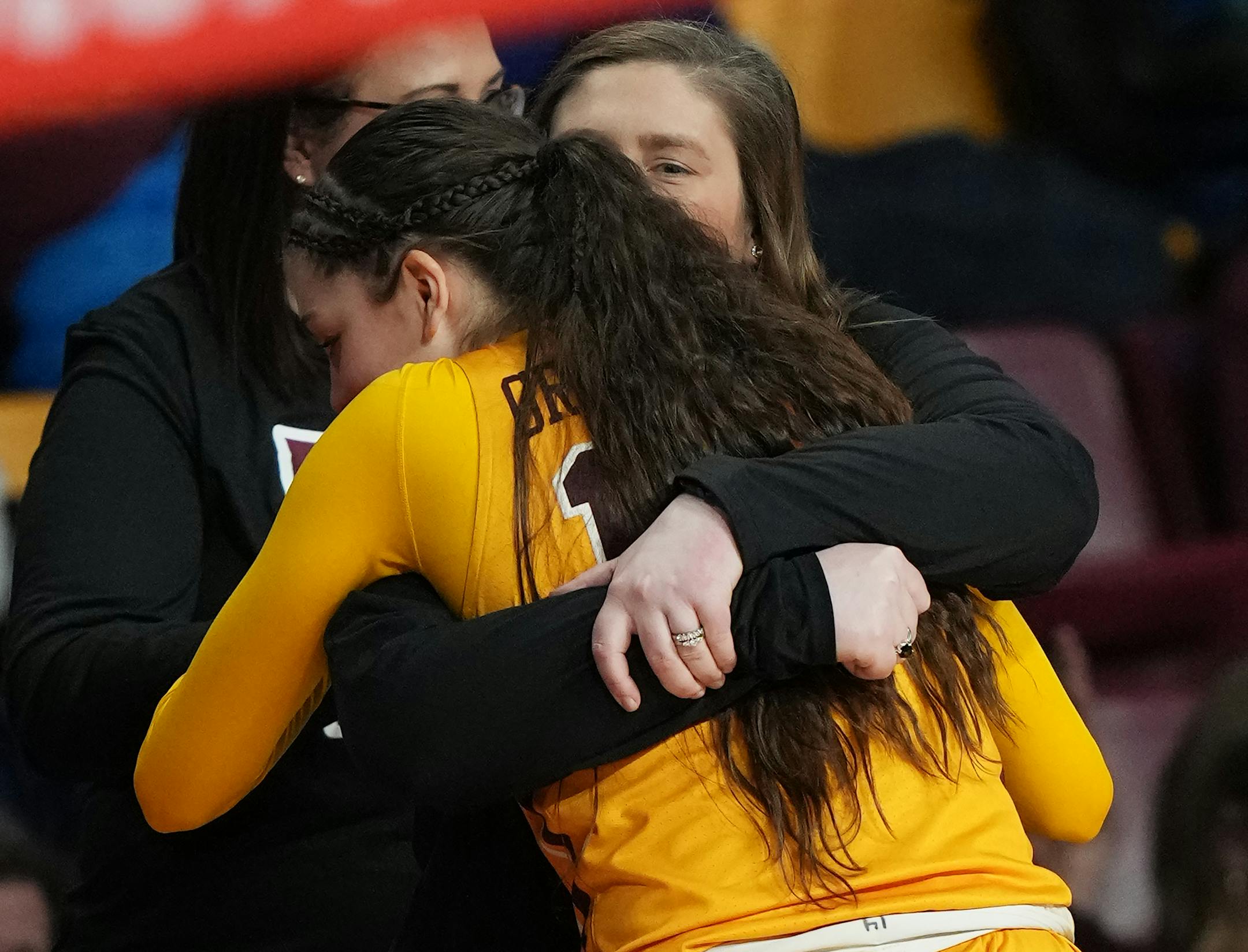 Minnesota Gophers head coach Lindsay Whalen hugs Isabelle Gradwell (14).
