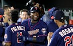 Minnesota Twins' Miguel Sano celebrates his two-run home run with teammates in the dugout in the ninth inning of a baseball game against the Baltimore