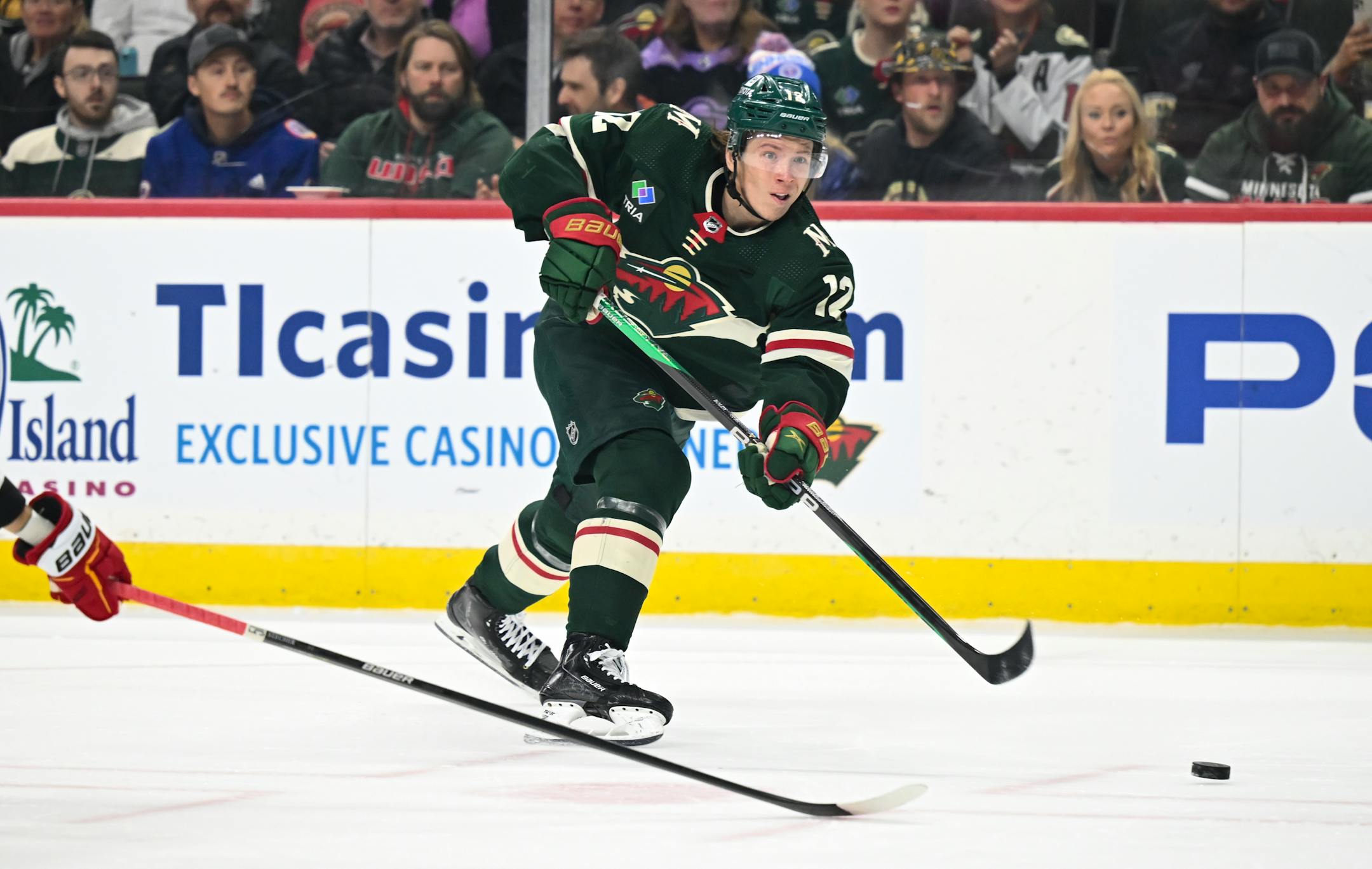 Minnesota Wild left wing Matt Boldy (12) attempts a shot against Calgary goaltender Jacob Markstrom (25) during the first period.