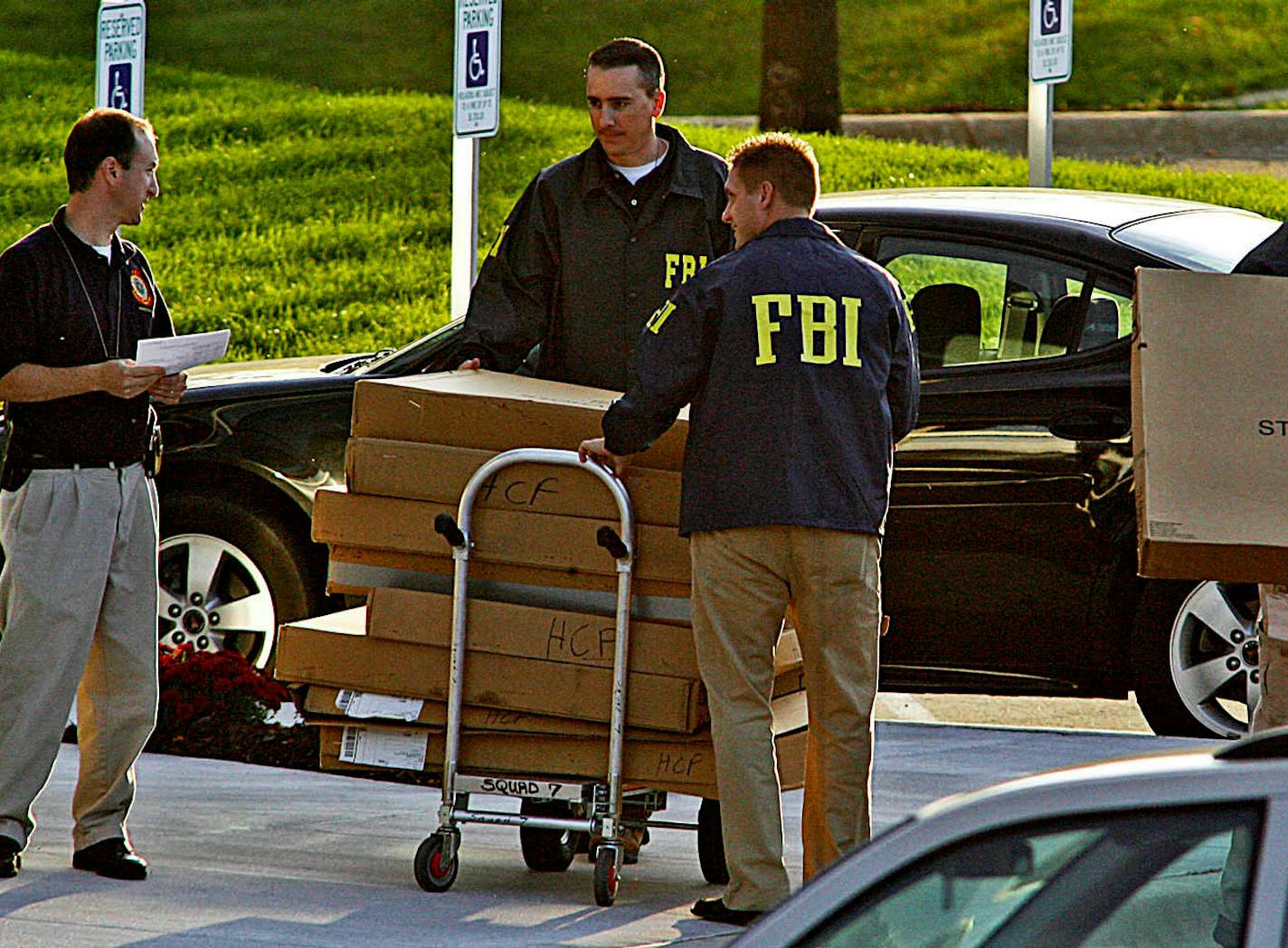 MARLIN LEVISON * mlevison@startribune.com Assign. #00005018A September 24, 2008] - GENERAL INFORMATION: The Petters Group headquarters in Minnetonka was raided by government agents including the FBI initiating an investigation into company business transactions. IN THIS PHOTO: FBI agents hauled boxes of unknown items from the Petters building to government vehicles in the parking lot.