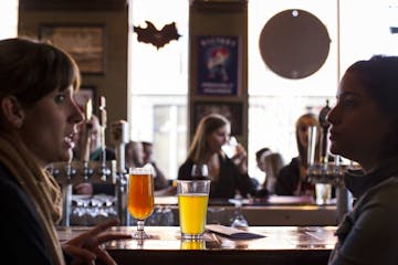 Diana Day, left, and Michaela Alessio enjoy happy hour at The Happy Gnome in St. Paul March 15, 2014.