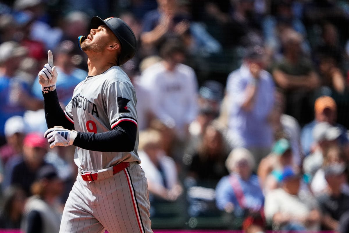 Twins outfielder Trevor Larnach points up as he crosses home plate following his tiebreaking two-run, eighth-inning homer in Seattle on Sunday.