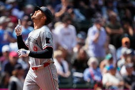 Twins outfielder Trevor Larnach points up as he crosses home plate following his tiebreaking, two-run, eighth-inning homer in Seattle on Sunday.