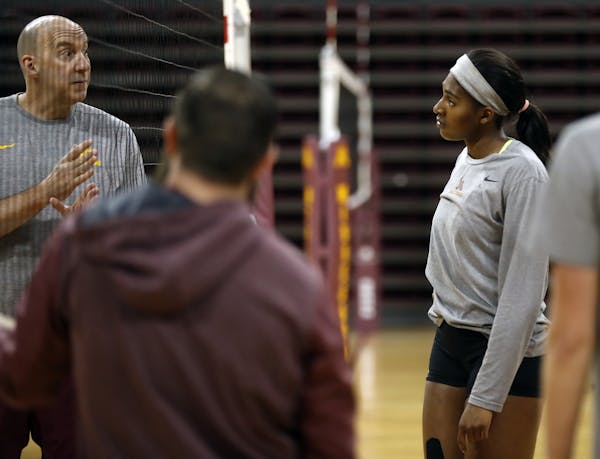 Head coach Hugh McCutcheon gives advice to Gophers volleyball super freshman Stephanie Samedy who has had an immediate impact on the team.]Richard Tso