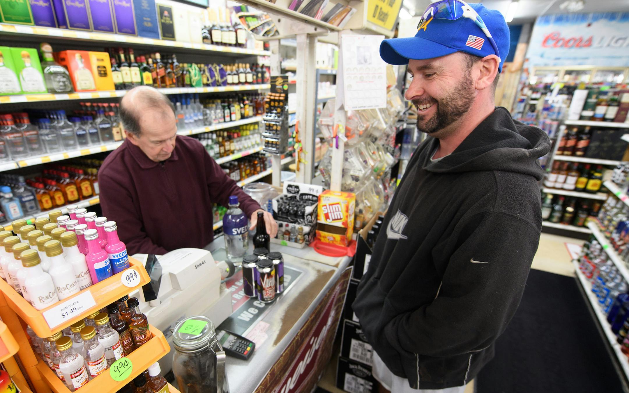 Highland resident Anthony Reid checks out at Premier Liquors on Sunday, March 4, 2018. (Kyle Telechan/Post Tribune/TNS)