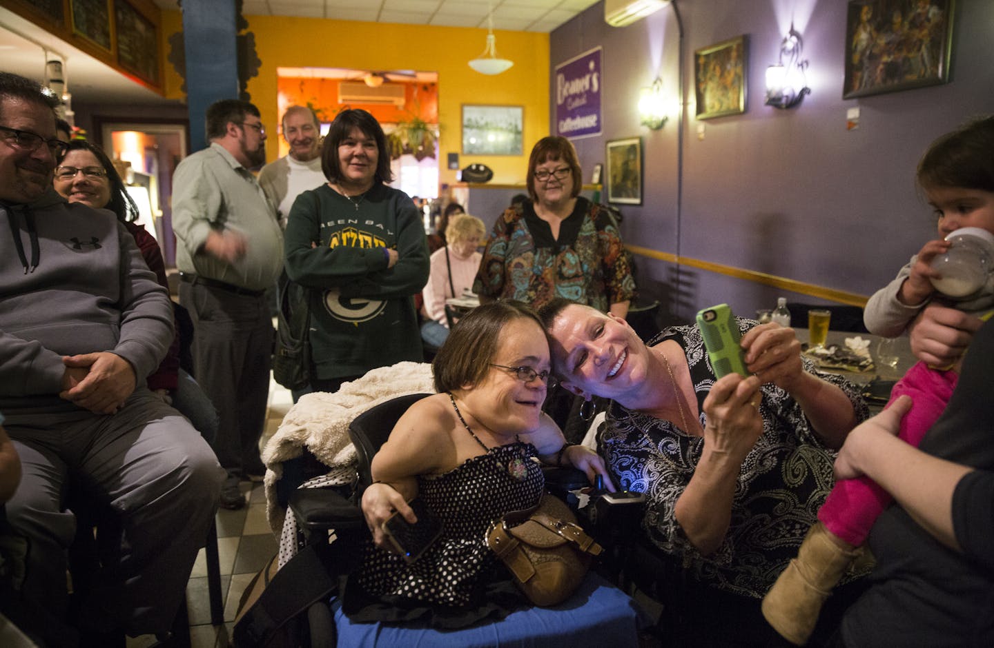 Gaelynn Lea posed for a photo with fan Carla Melander before performing at Beaner's Central Coffee House in Duluth.