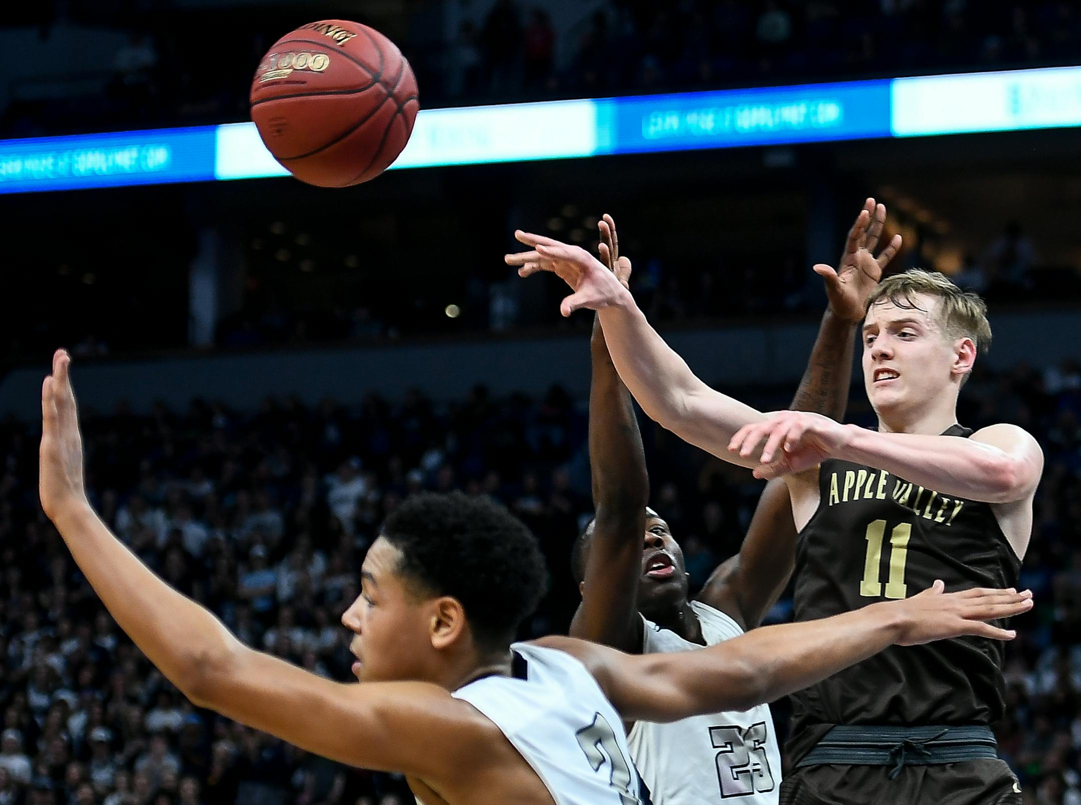 Apple Valley guard Luke Martens (11) passed away the ball in traffic while being defended by Champlin Park guard McKinley Wright IV (25) in the second half Saturday. ] AARON LAVINSKY ï aaron.lavinsky@startribune.com Apple Valley played Champlin Park in the Class 4A State Tournament Championship Game on Saturday, March 25, 2017 at Target Center in Minneapolis, Minn.