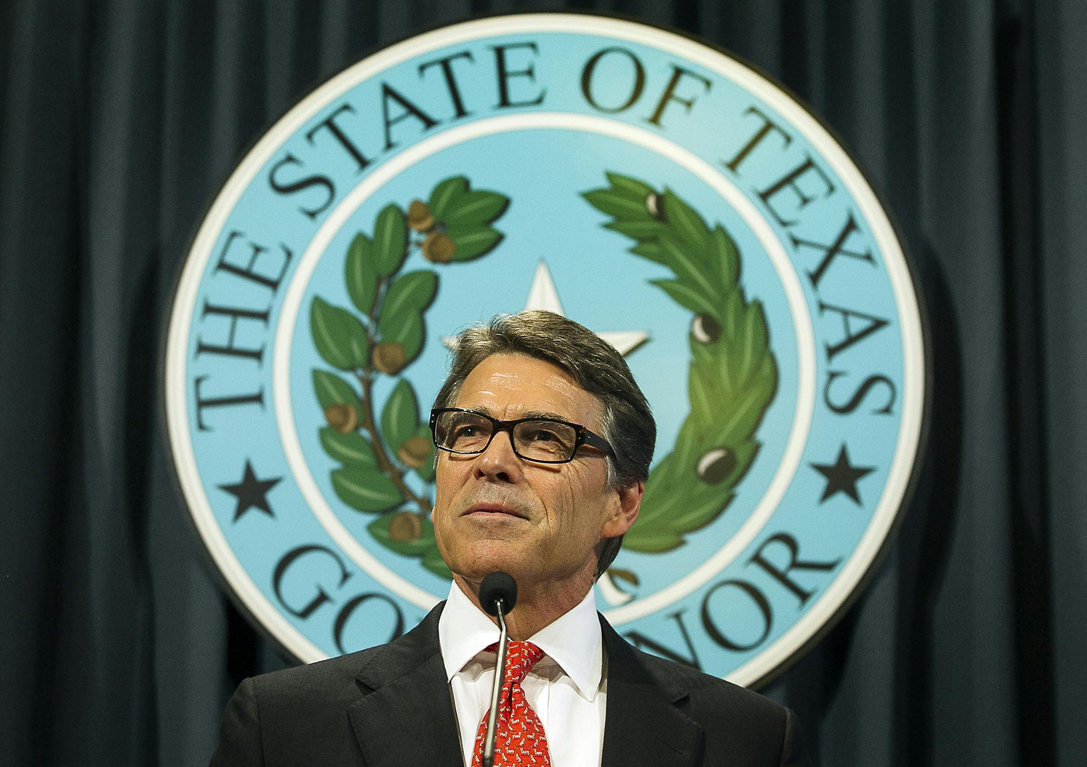 Texas Gov. Rick Perry speaks during a news conference on Saturday, Aug. 16, 2014, in Austin, Texas. Perry said Saturday that the indictment against him was an "outrageous" abuse of power and vowed to fight it. (AP Photo/Austin American-Statesman, Rodolfo Gonzalez) AUSTIN CHRONICLE OUT, COMMUNITY IMPACT OUT, INTERNET AND TV MUST CREDIT PHOTOGRAPHER AND STATESMAN.COM, MAGS OUT