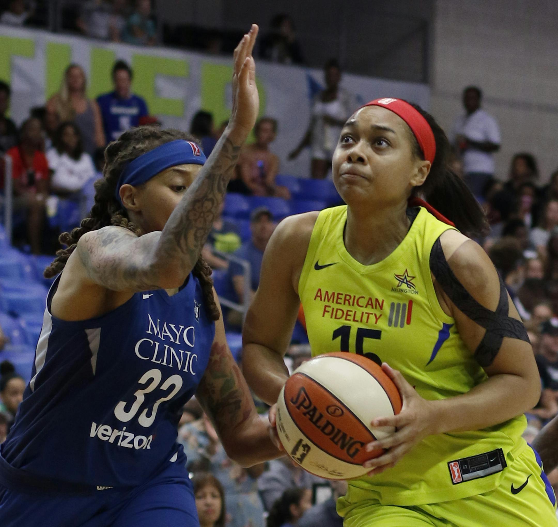 Dallas Wings guard Allisha Gray (15) drives to the basket past the defense of Minnesota Lynx guard Seimone Augustus (33) during first-half action of a WNBA basketball game Sunday, July 1, 2018, in Arlington, Texas. (Steve Hamm/The Dallas Morning News via AP)