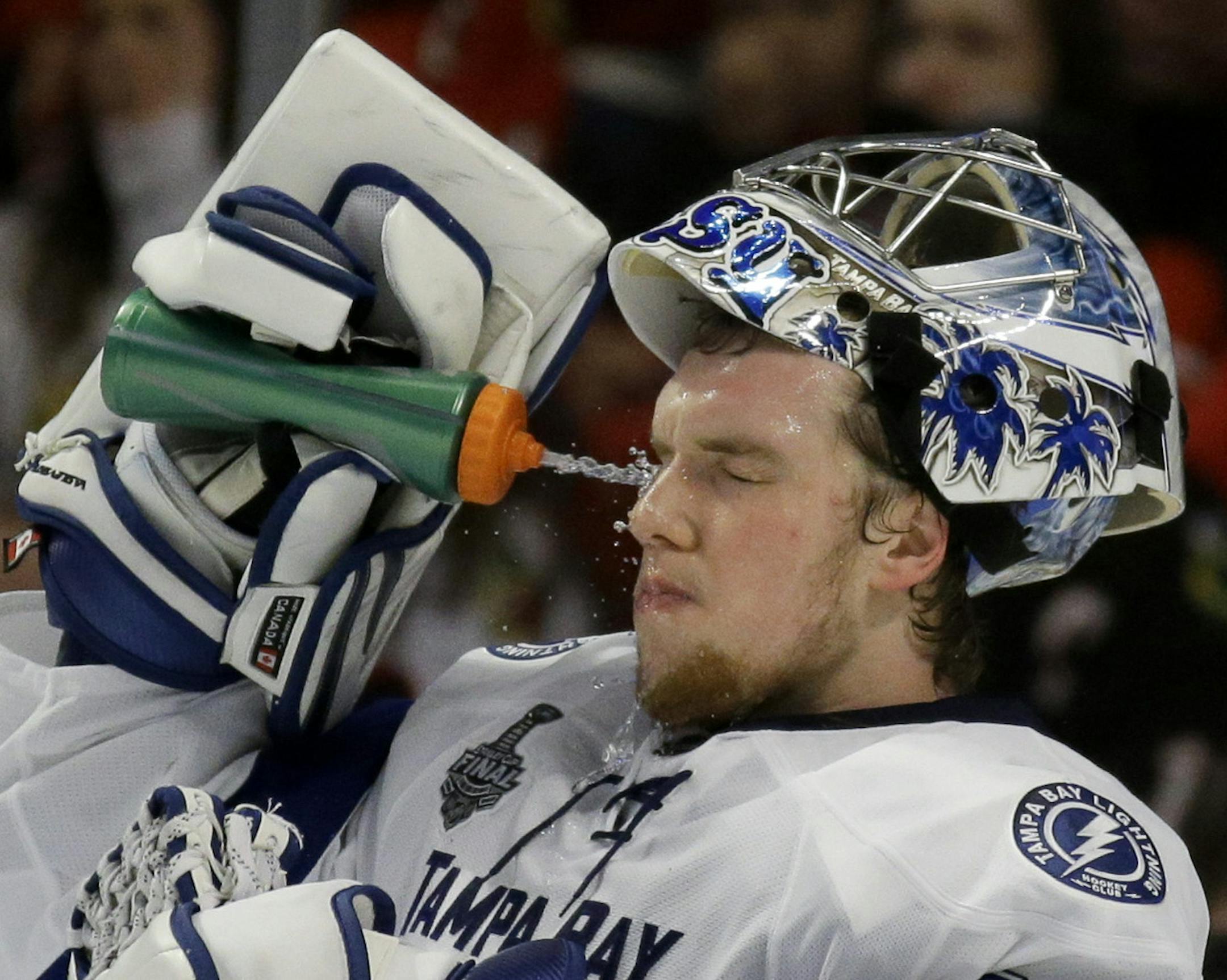 Tampa Bay Lightning goalie Andrei Vasilevskiy sprays his face during the second period in Game 4 of the NHL hockey Stanley Cup Final against the Chicago Blackhawks Wednesday, June 10, 2015, in Chicago. (AP Photo/Nam Y. Huh)