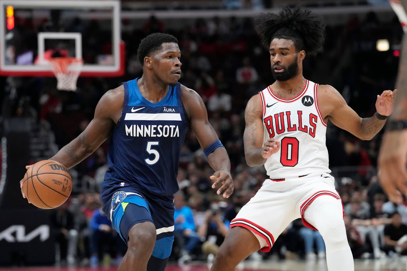 Minnesota Timberwolves guard Anthony Edwards, left, drives as Chicago Bulls guard Coby White guards during the first half of an NBA preseason basketball game in Chicago, Thursday, Oct. 19, 2023. (AP Photo/Nam Y. Huh)