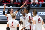 Carter Booth, shown here being surrounded by her Badgers teammates, is leading the Big Ten in hitting percentage and blocks per set in her first seaso