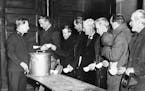 In early years of the depression private agencies such as the Salvation Army were relied upon to give aid to to the unemployed. Phot shows men at a "S
