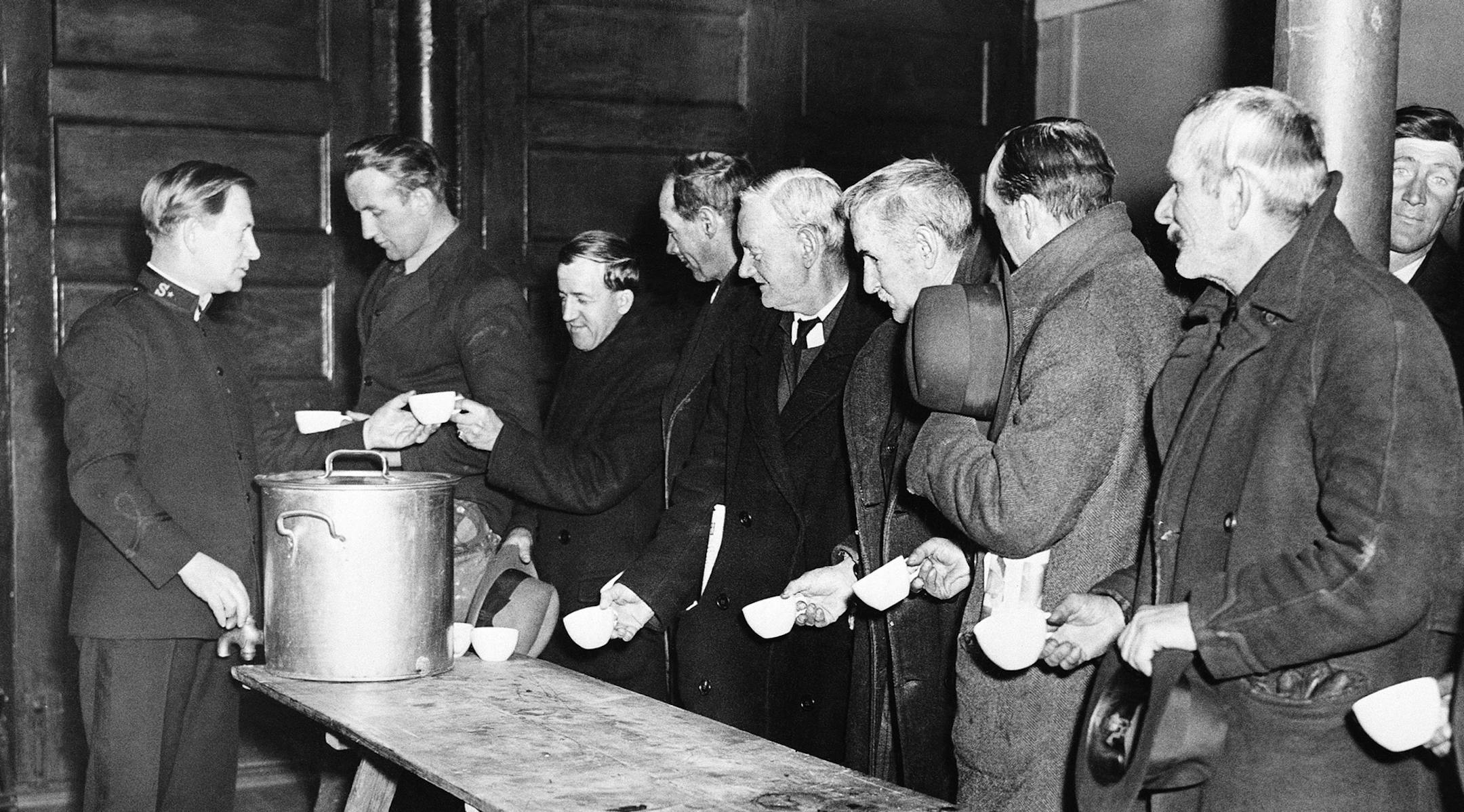 In early years of the depression private agencies such as the Salvation Army were relied upon to give aid to to the unemployed. Phot shows men at a "Soup Kitchen" January 30, 1934. (AP Photo) ORG XMIT: APHS47722