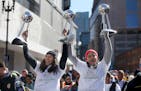 Seimone Augustus, left, and Maya Moore held up three of their WNBA trophies during a 2015 championship parade.