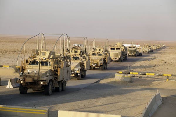 The last vehicles in a convoy of the U.S. Army's 3rd Brigade, 1st Cavalry Division crosses the border from Iraq into Kuwait, Sunday, Dec. 18, 2011. Th