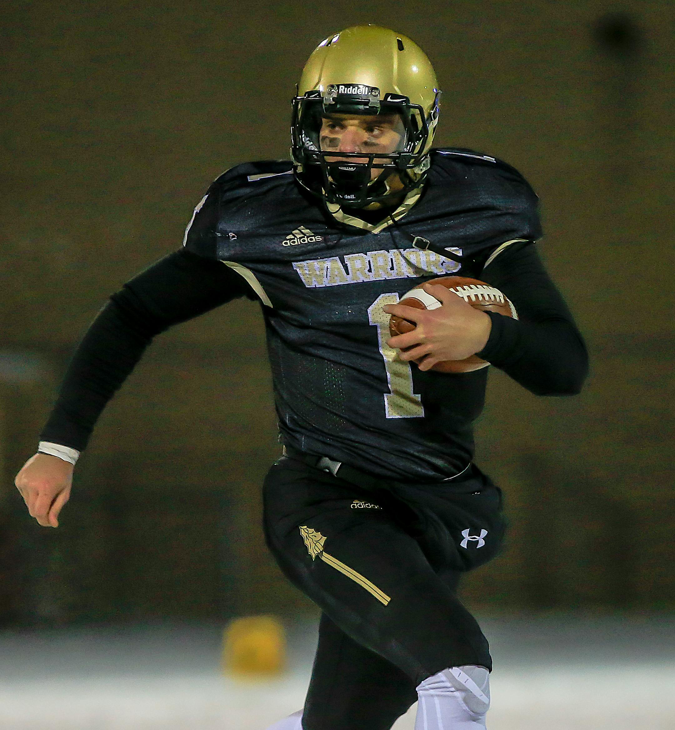 Caledonia quarterback Noah King turns the corner on a run attempt in the second quarter. King scored two touchdowns as Caledonia raced to a 34-0 halftime lead over New Richland-Hartland-Ellendale-Geneva in a Class 2A state tournament quarterfinal at Burnsville High School. Photo by Mark Hvidsten, SportsEngine
