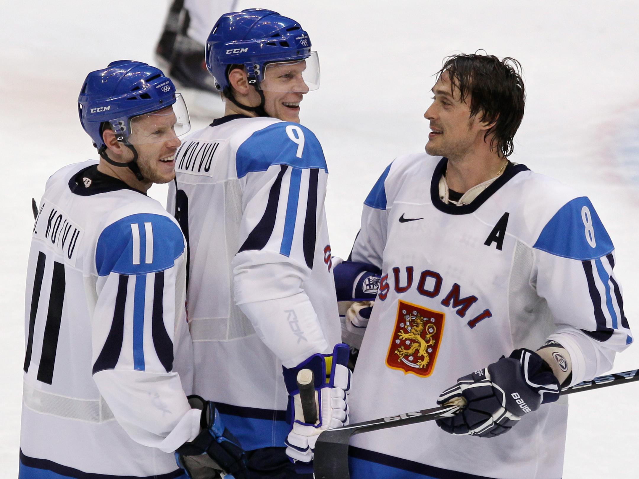 Finland's Teemu Selanne (8) talks with Mikko Koivu (9) and Saku Koivu (11) after beating Germany 5-0 in a preliminary round men's ice hockey game at the 2010 Olympics in Vancouver, British Columbia.