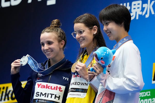 Medalists Regan Smith of the U.S., silver, Kaylee McKeown of Australia, gold, and Peng Xuwei of China, bronze, celebrate during the medal ceremony for
