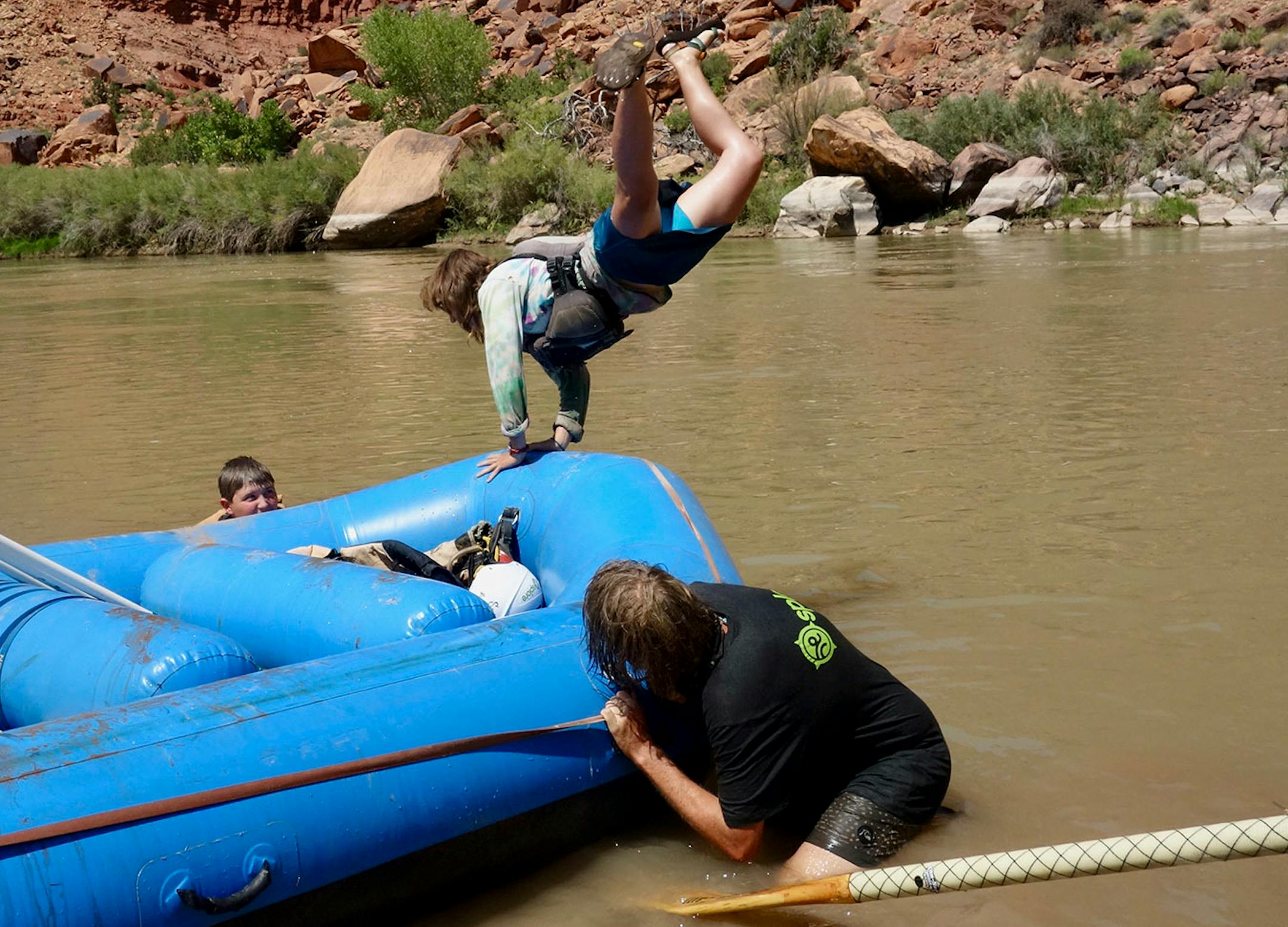 Brayden Buchta, Mel Leviner and Lucien Blakemore (left to right), celebrate the end of or trip with cartwheels into the river.