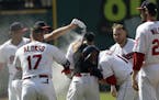 Cleveland Indians teammates mob Michael Brantley after he hit the game-winning RBI-single in the ninth inning of a baseball game against the Minnesota