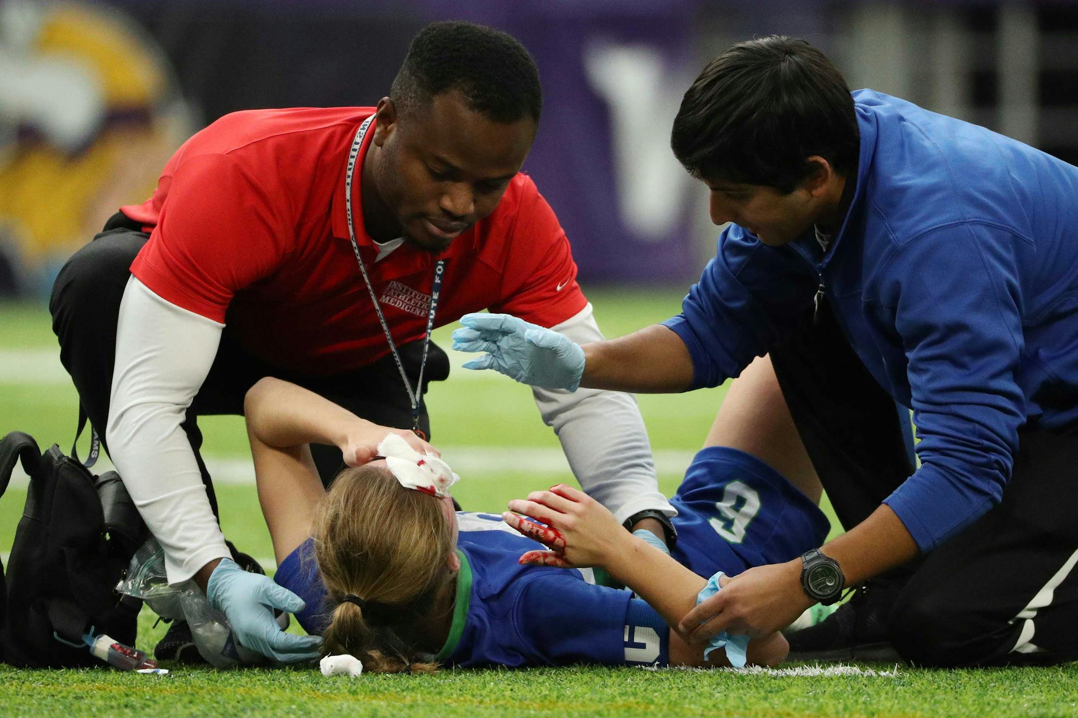 Eagan High School defender Lauren Boike (6) was tended to by medical staff after she suffered a head injury in the first half of a state tournament semifinal game on Tuesday.