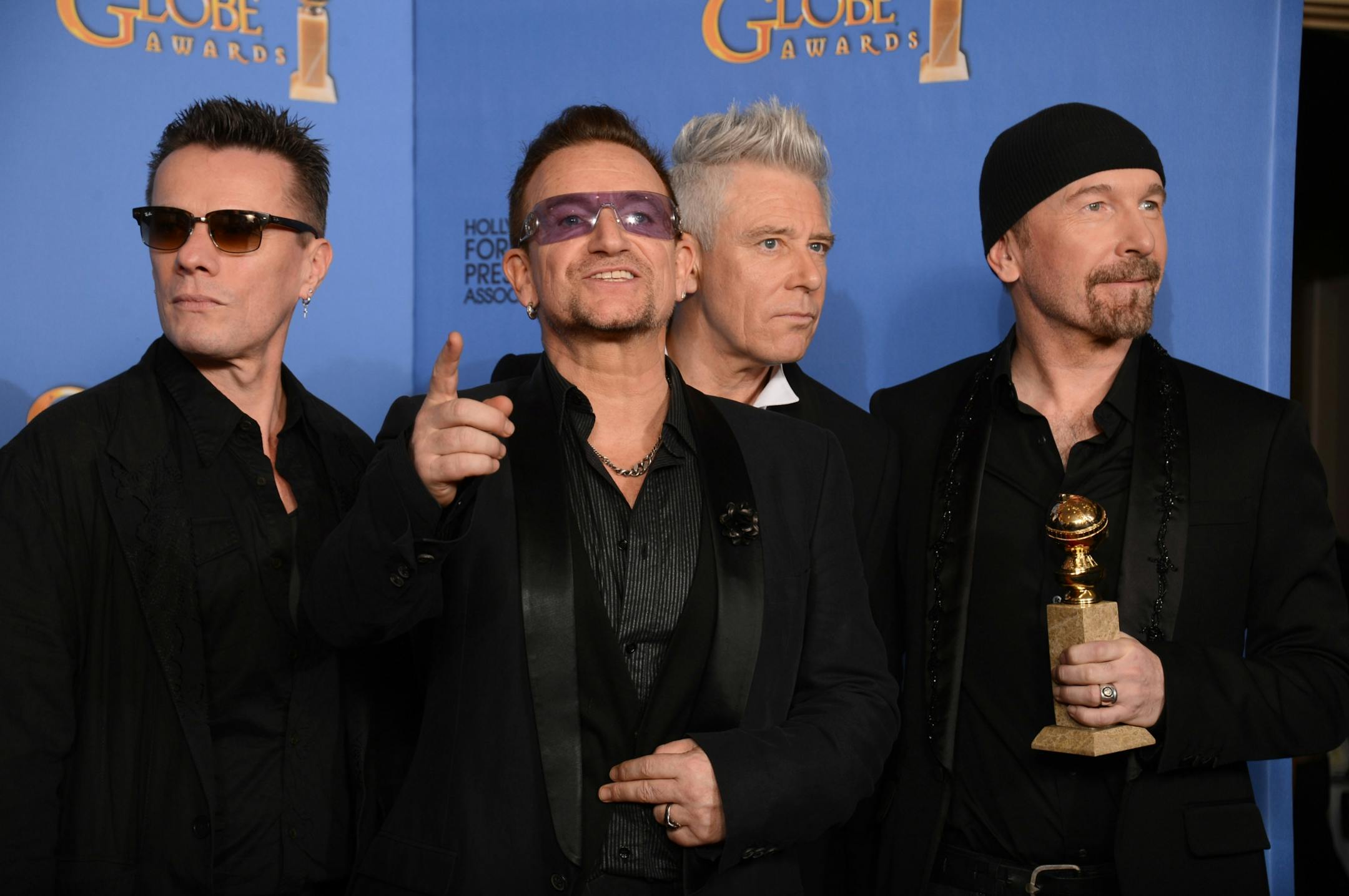 From left, Larry Mullen Jr., Bono, Adam Clayton, and The Edge of U2 pose in the press room with the award for best original song for "Ordinary Love" from the film "Mandela: Long Walk to Freedom" at the 71st annual Golden Globe Awards at the Beverly Hilton Hotel on Sunday, Jan. 12, 2014, in Beverly Hills, Calif.