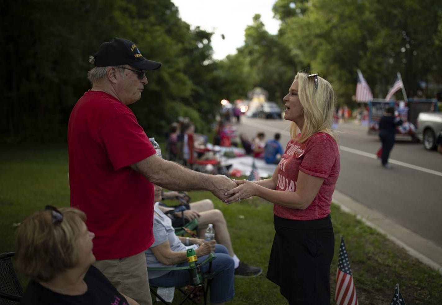 Karin Housley shook hands with Phil Rosar, 70, of Coon Rapids while campaigning during the Coon Rapids Fourth of July parade Monday evening.