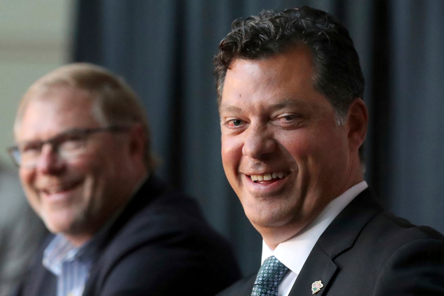 Minnesota Wild NHL hockey team owner Craig Leipold, left, laughs with new team general manager Bill Guerin at an introductory press conference in St. Paul, Minn., Thursday, Aug. 22, 2019. (David Joles/Star Tribune via AP)