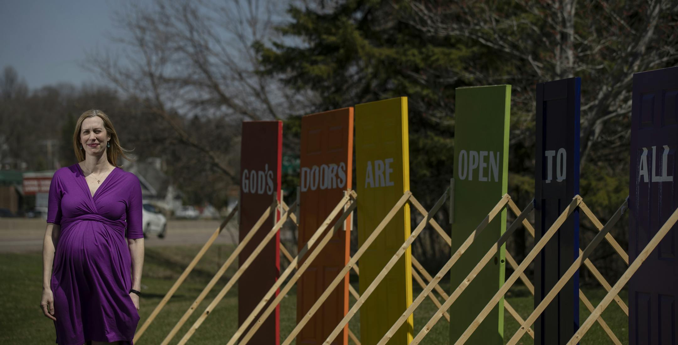 Rev. Brooke Heerwald Steiner of Excelsior United Methodist Church posed with a series of six rainbow colored doors on its lawn Thursday April 25, 2019 in Excelsior, MN.] . Jerry Holt • Jerry.holt@startribune.com