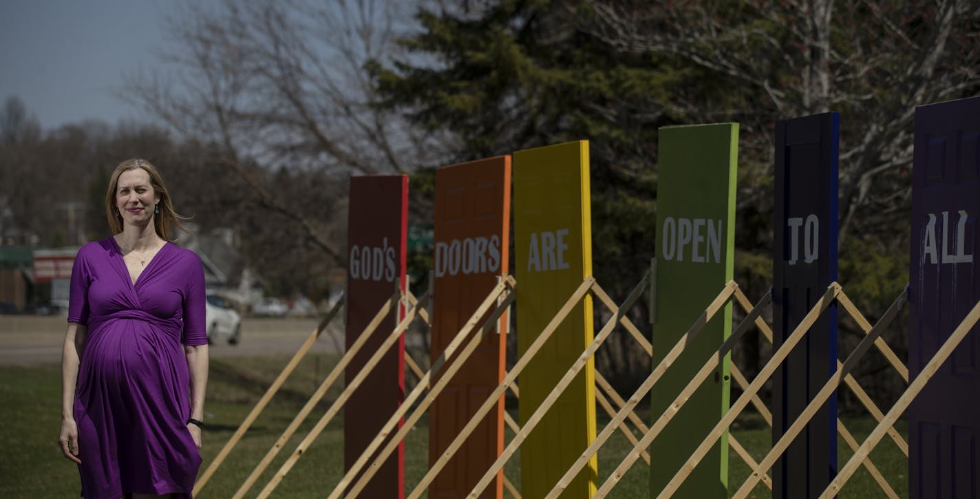 Rev. Brooke Heerwald Steiner of Excelsior United Methodist Church posed with a series of six rainbow colored doors on its lawn Thursday April 25, 2019 in Excelsior, MN.] . Jerry Holt &#x2022; Jerry.holt@startribune.com