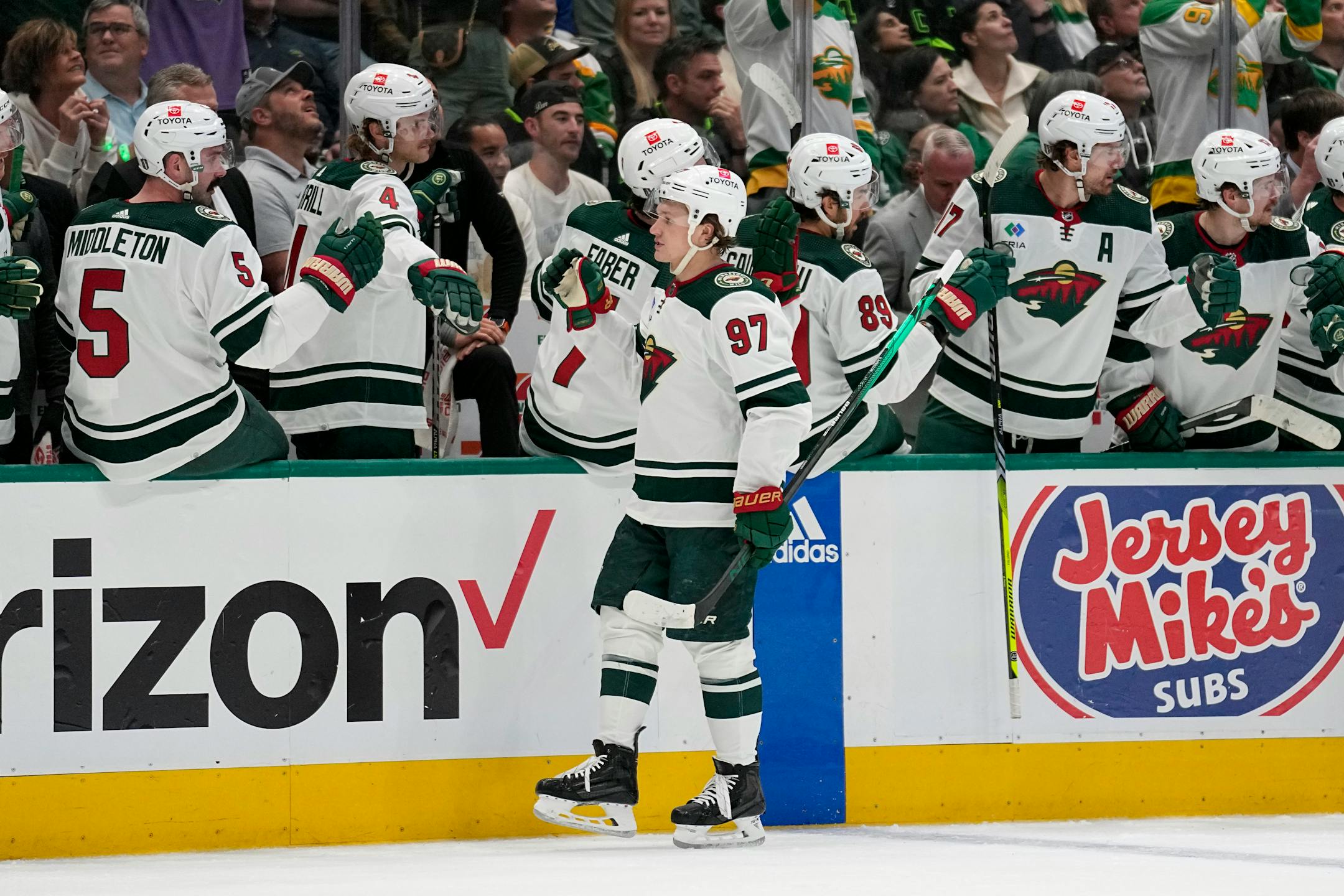 Minnesota Wild left wing Kirill Kaprizov (97) celebrates with the bench after scoring against the Dallas Stars during the first period.