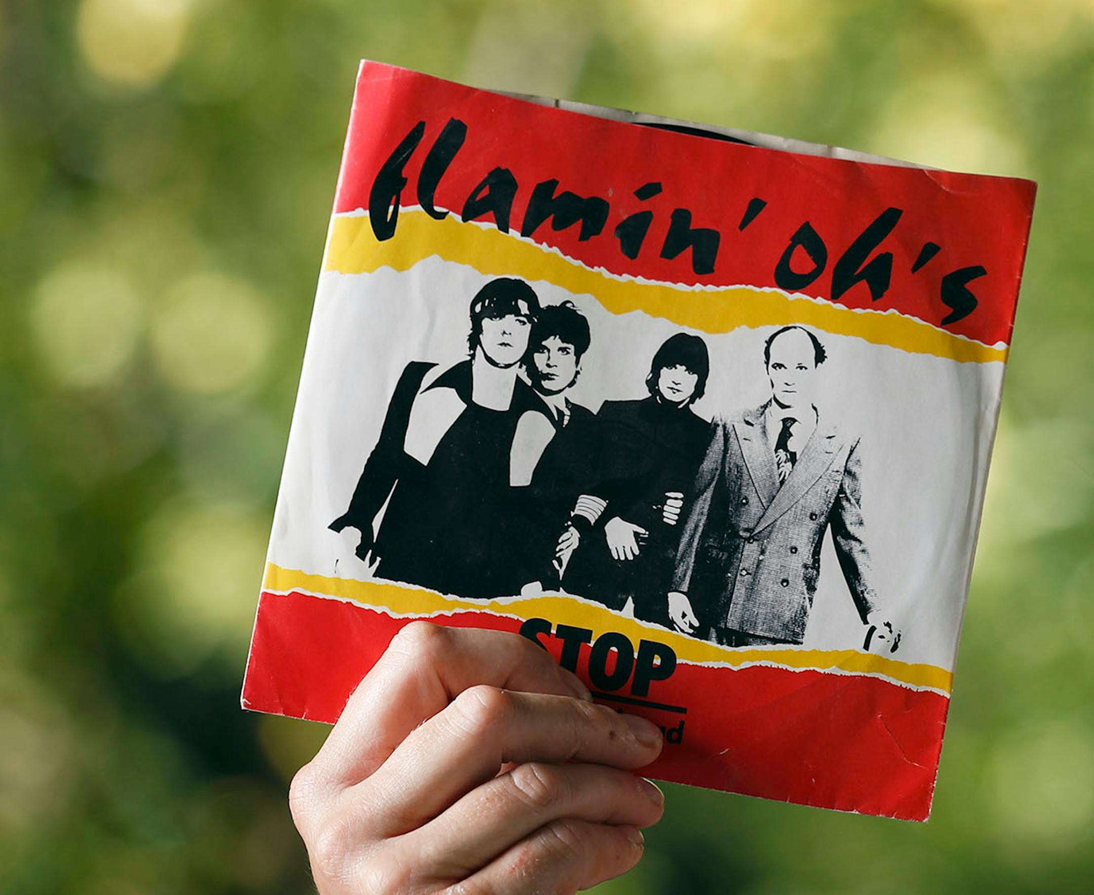 Barbara Behrend widow of Joseph Behrend held a cover of a recording that the Flaming� Oh�s recorded in the eighties near her home Monday August 15, 2016 in Delano, MN. The red Epiphone guitar is believed to be the murder weapon.