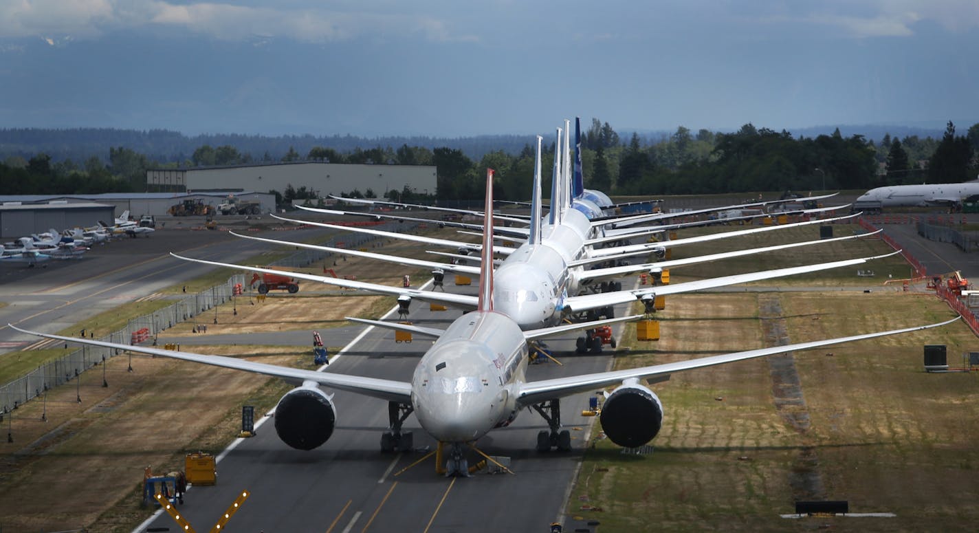 A line of Boeing 787 Dreamliners waiting to be delivered are shown on a closed runway on Tuesday, June 18, 2013 at Paine Field near Boeing's Everett, Wash. assembly plant.