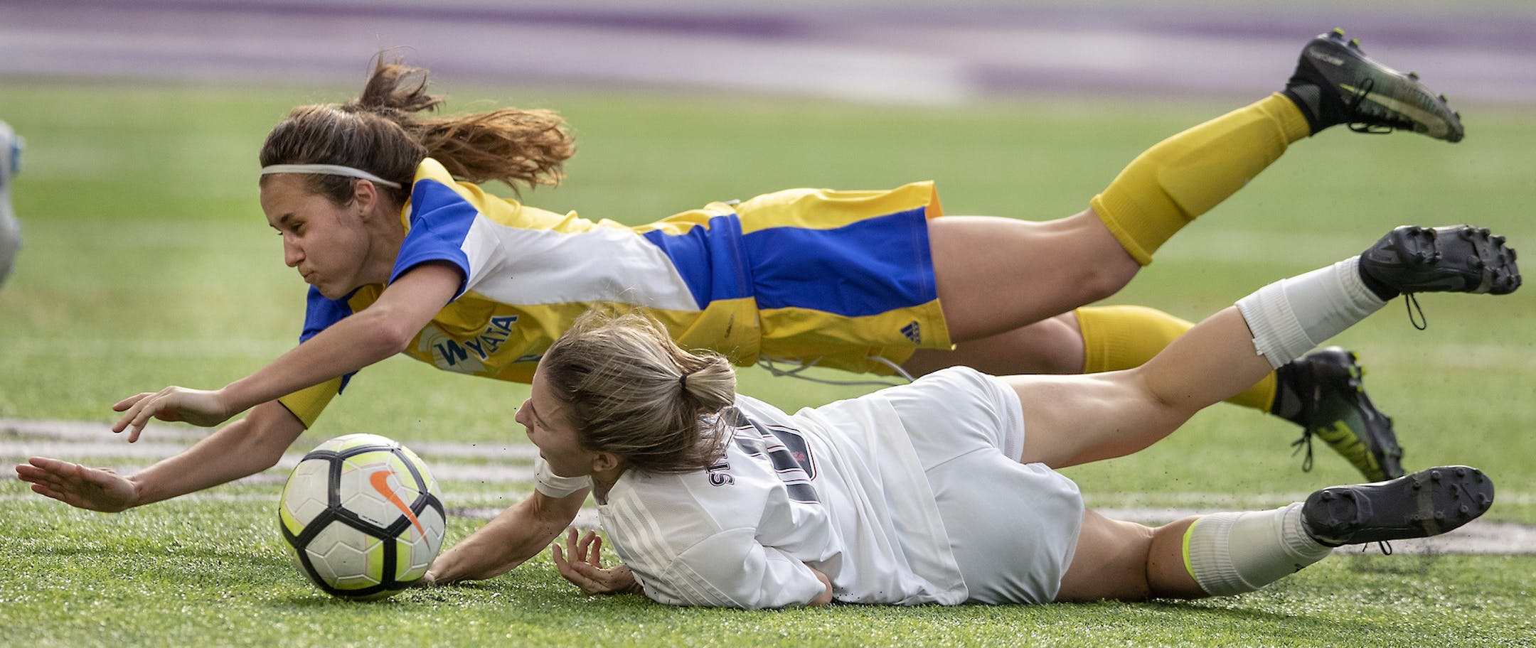 Wayzata's Eva Bruer, left, and Stillwater's Abby Begin battled for the ball on the field during the second overtime of the Class 2A girls' soccer semifinals matchup between Stillwater and Wayzata at US Bank Stadium, Tuesday, October 30, 2018 in Minneapolis, MN. ] ELIZABETH FLORES ï liz.flores@startribune.com