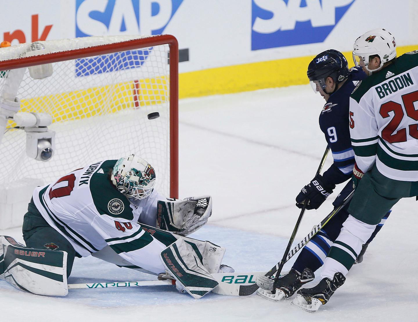 Winnipeg Jets' Andrew Copp (9) scores on Minnesota Wild goaltender Devan Dubnyk (40) as Jonas Brodin (25) defends during the third period of Game 2 of an NHL hockey first-round playoff series Friday, April 13, 2018, in Winnipeg, Manitoba. (John Woods/The Canadian Press)