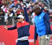 23 time Olympic gold medalist Michael Phelps stretched as retired English Olympic sprinter John Regis set up his shot at the first tee during the Ryde