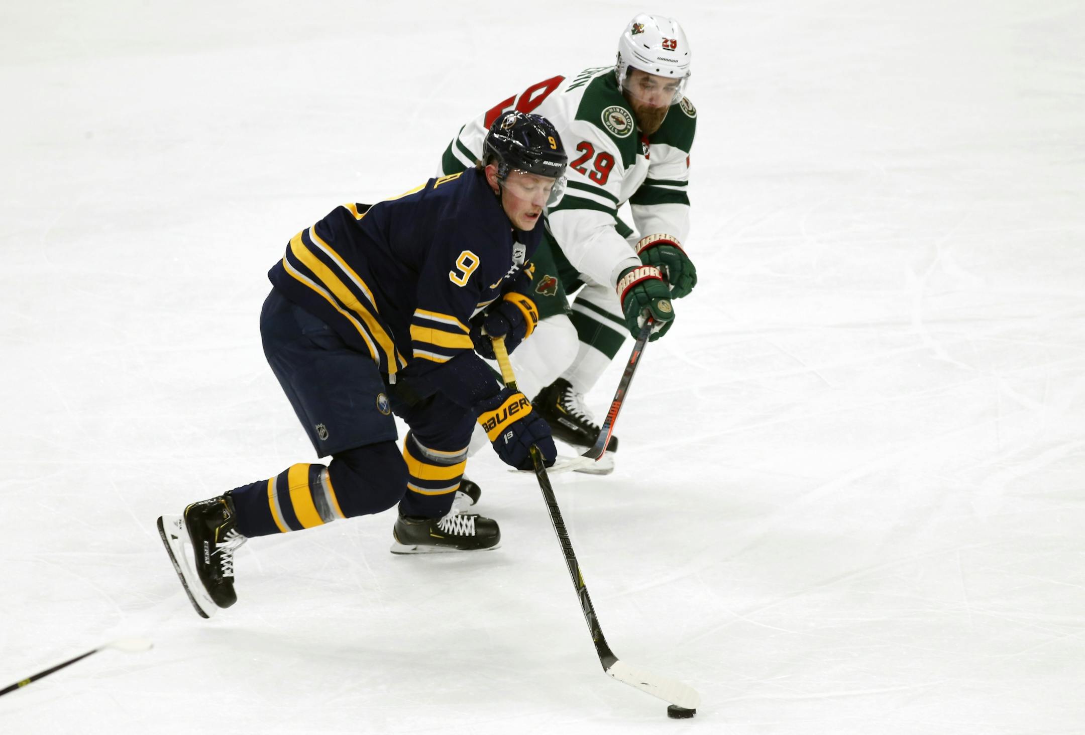 Buffalo Sabres forward Jack Eichel (9) carries the puck past Minnesota Wild defenseman Greg Pateryn (29) during the first period of an NHL hockey game, Tuesday, Feb. 5, 2019, in Buffalo N.Y.