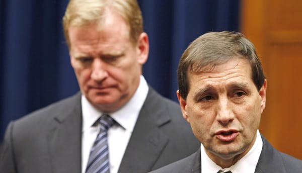 FILE - In this Oct. 14, 2011, file photo, NFL football lead counsel Jeff Pash, right, accompanied by NFL Commissioner Roger Goodell, speaks with repor