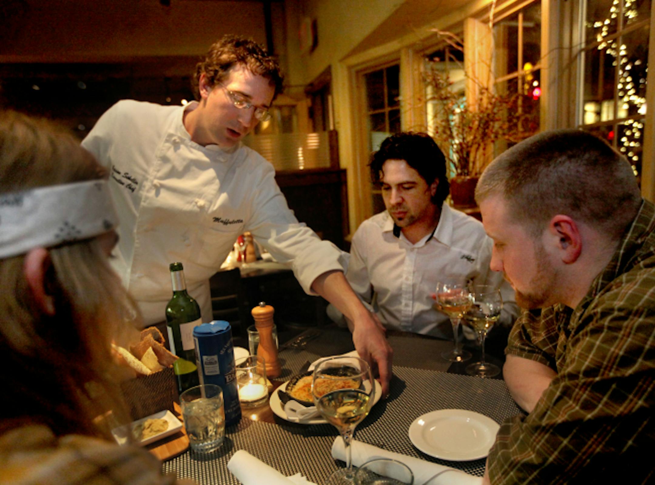 Sunday service: Muffuletta chef Jason Schellin serves a shrimp dish to (clockwise, from left) Ray Wyatt, Ray Sauter and Brandon McCormick-Guthu.